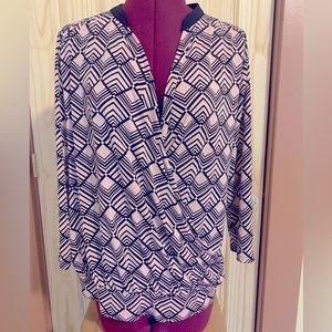 Pink and black wrap blouse with waistband detail.